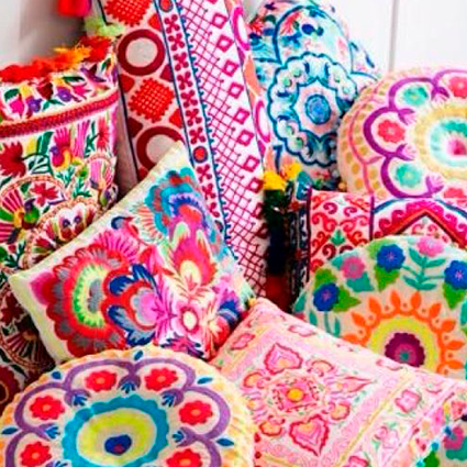 Conjunto de almofadas coloridas, de cor predominante rosa, com padrões florais